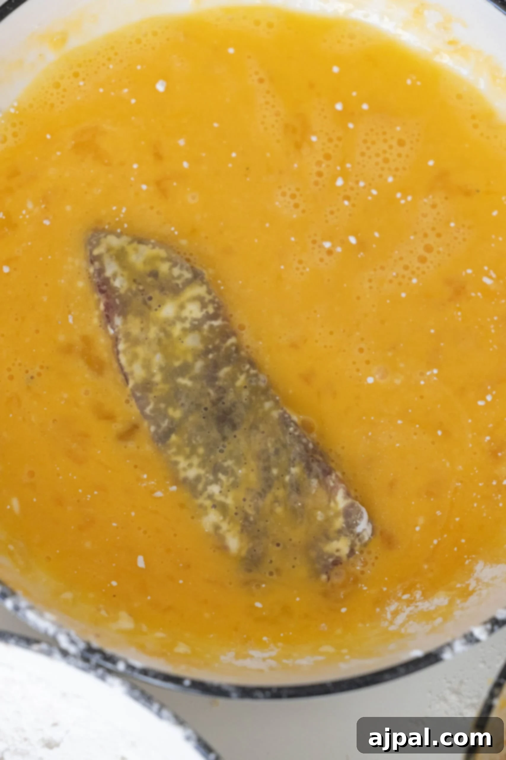 Steak being dipped in egg