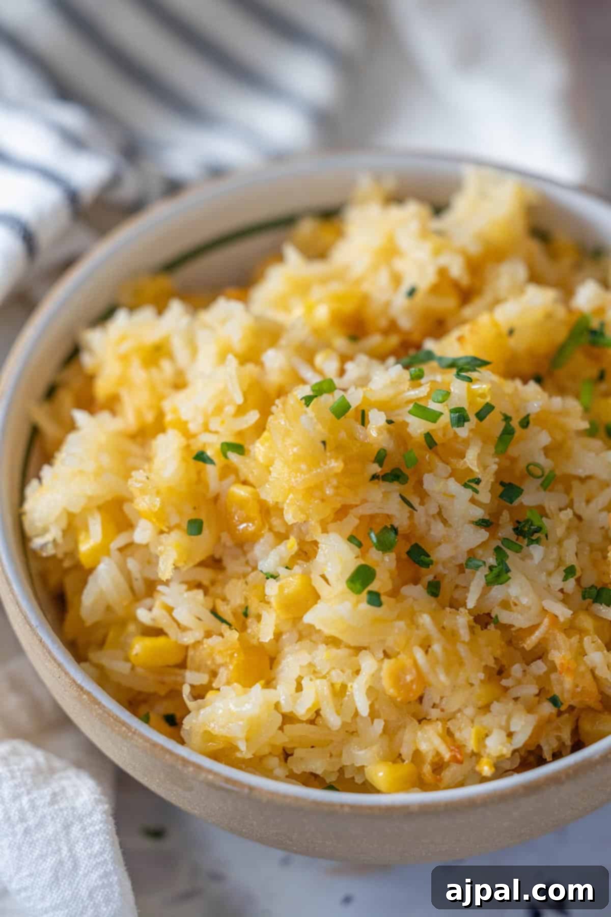 Bowl of Cheesy Corn and Rice Casserole with Herbs