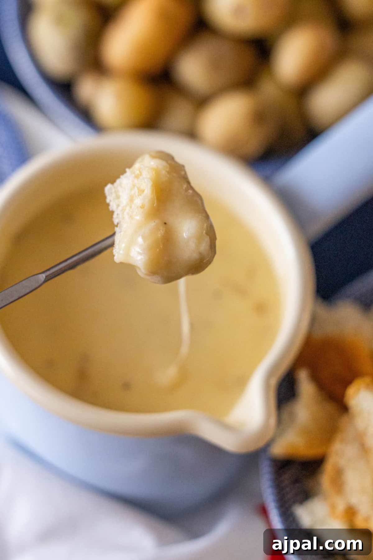 Bread dipped in cheese fondue