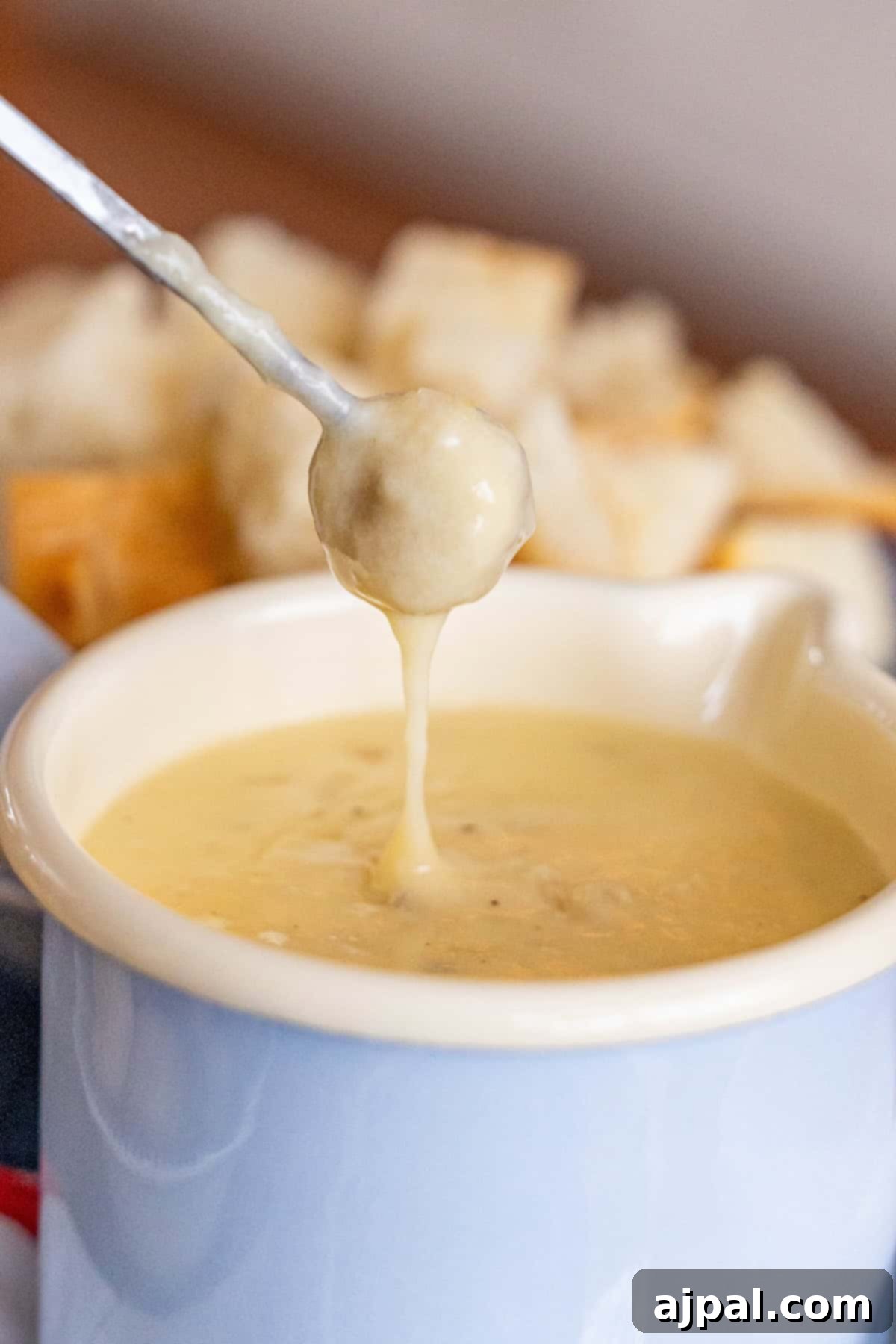 Spoon of cheese fondue