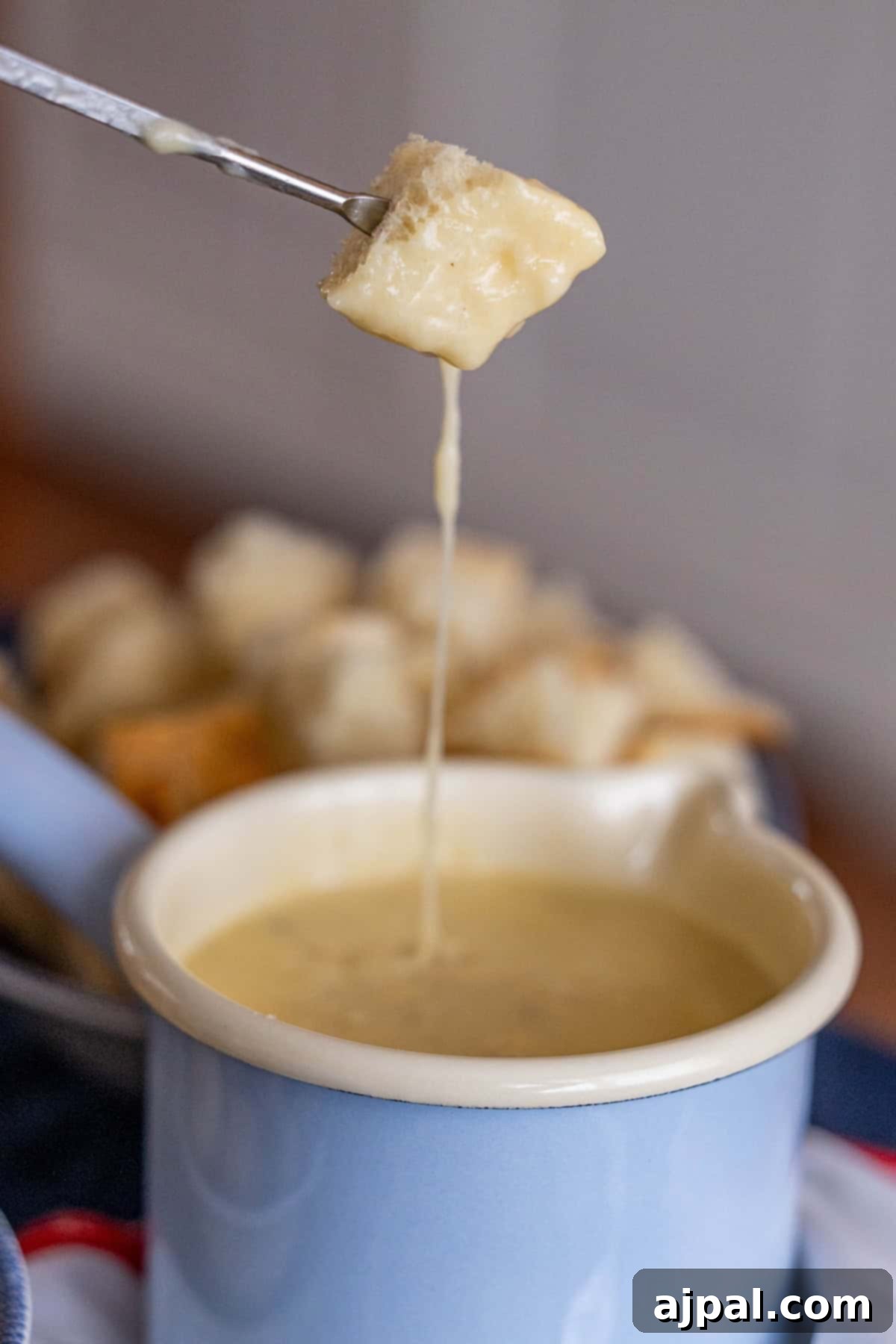 Fork with bread dipped in fondue