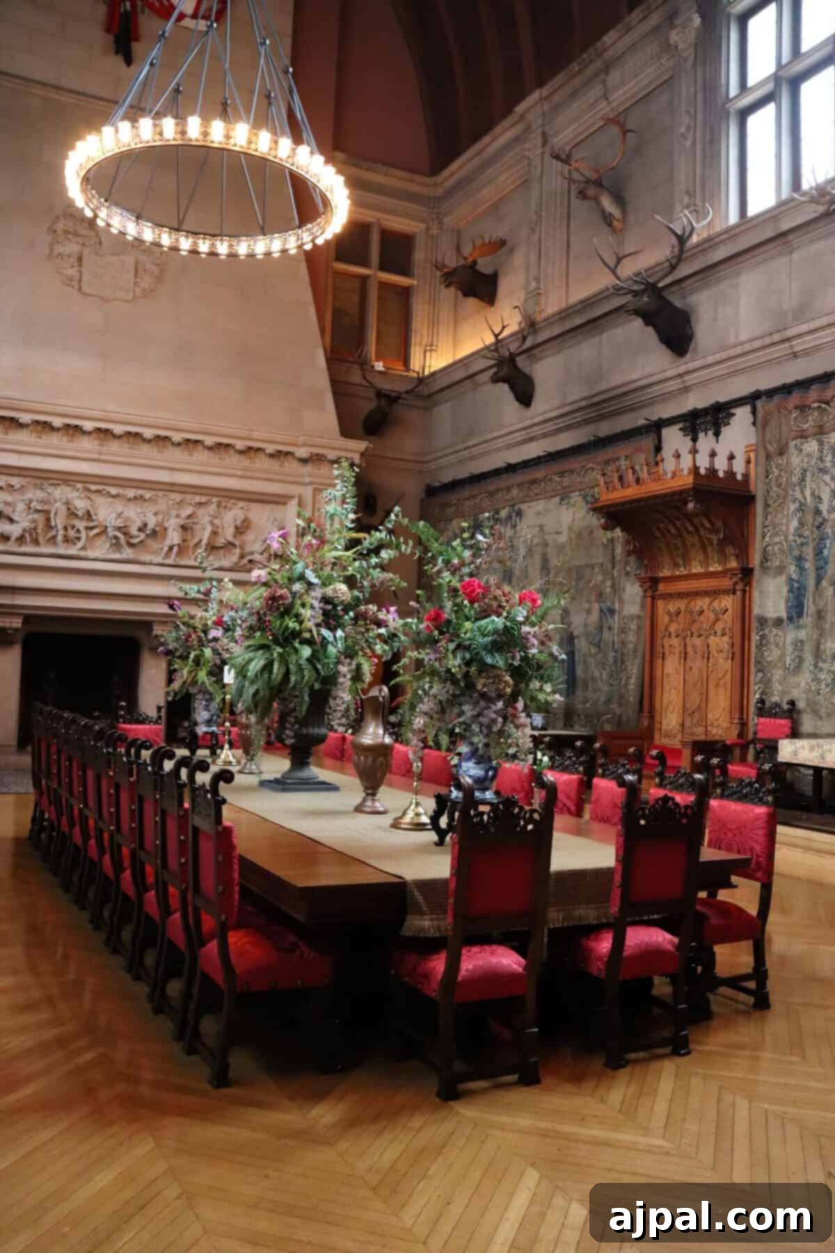 Ornate dining table with red-cushioned chairs at Biltmore