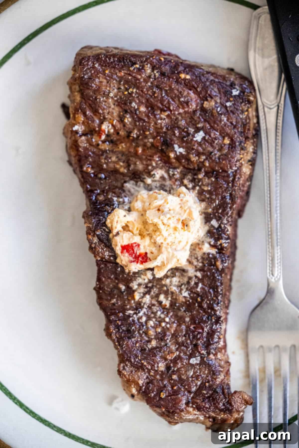 Denver Steak
Denver Cut Delight 3 Denver Steak topped with seasoned butter on a white plate