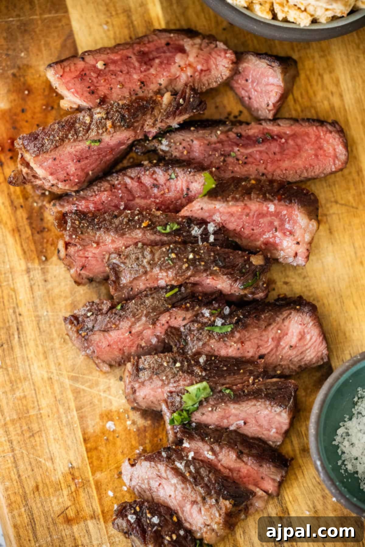 Sliced Denver Steak seasoned with salt and pepper