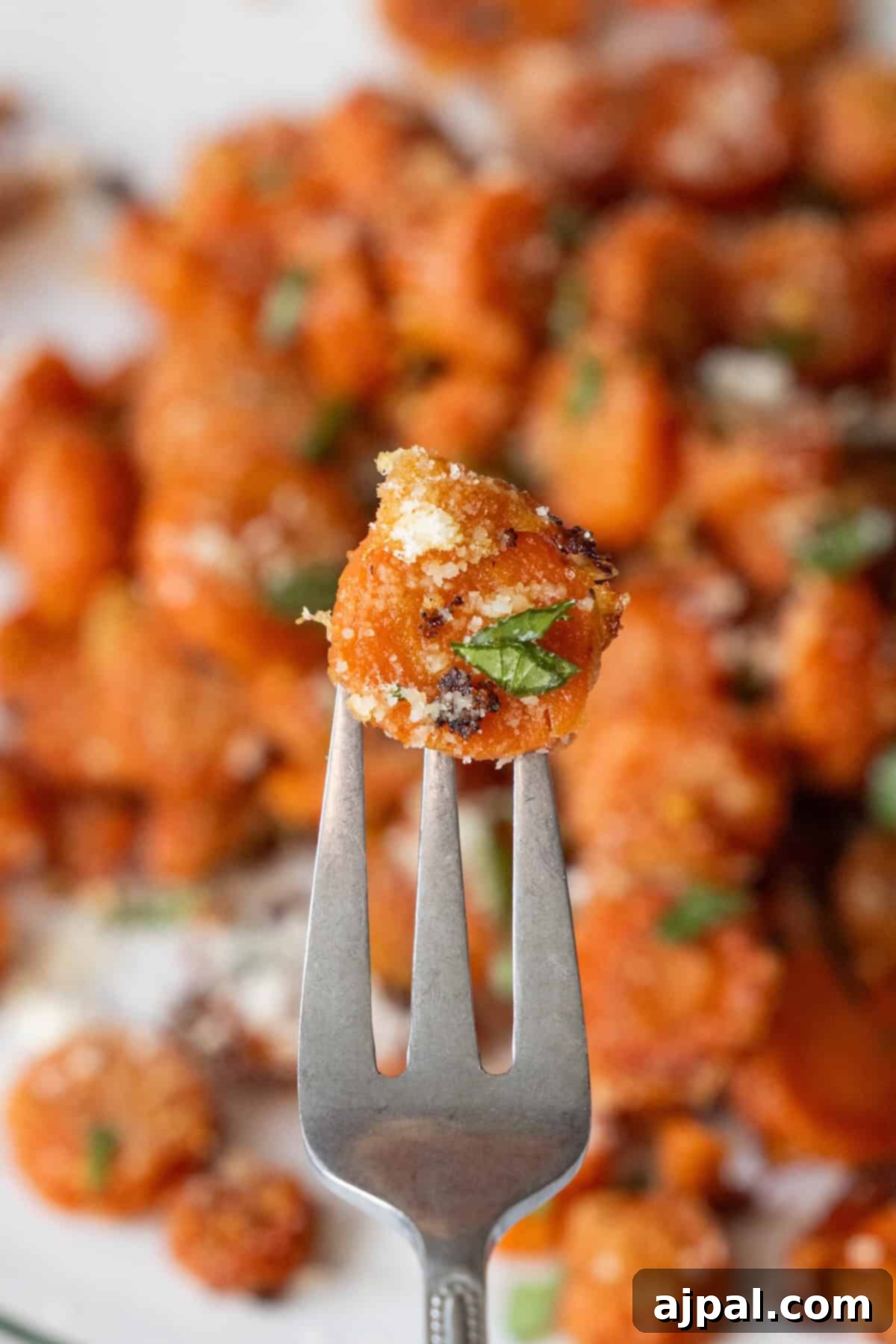 Close-up of a fork holding Garlic Parmesan Roasted Carrot
