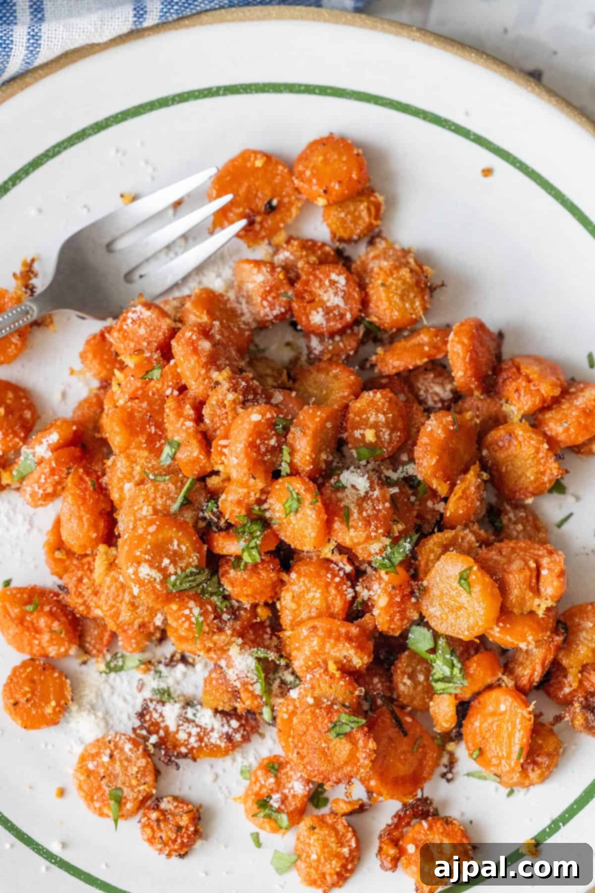 Garlic Parmesan Roasted Carrots served on a plate with a fork