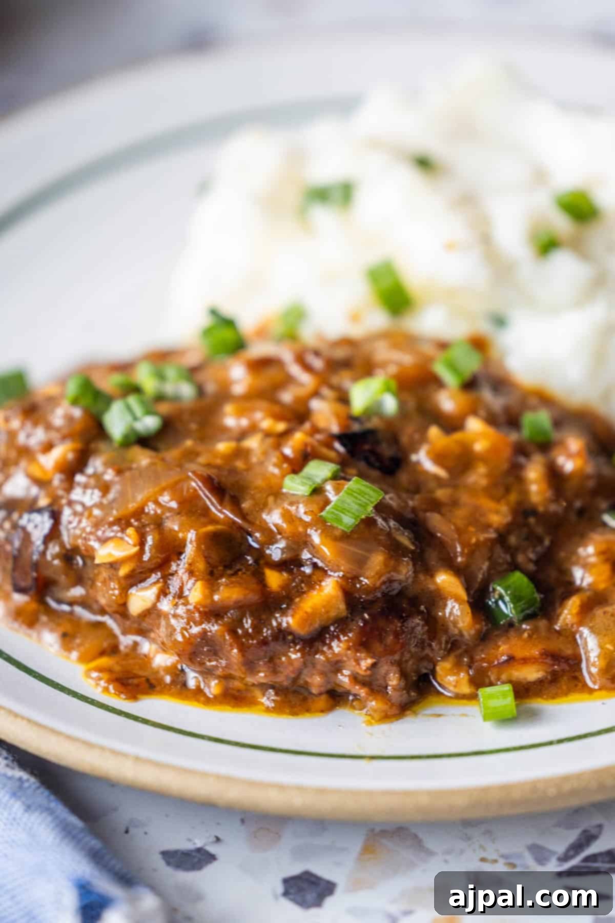 Country Steak in Gravy: A Hearty Homestyle Classic 12 Finished country steak with onion gravy and mashed potatoes.