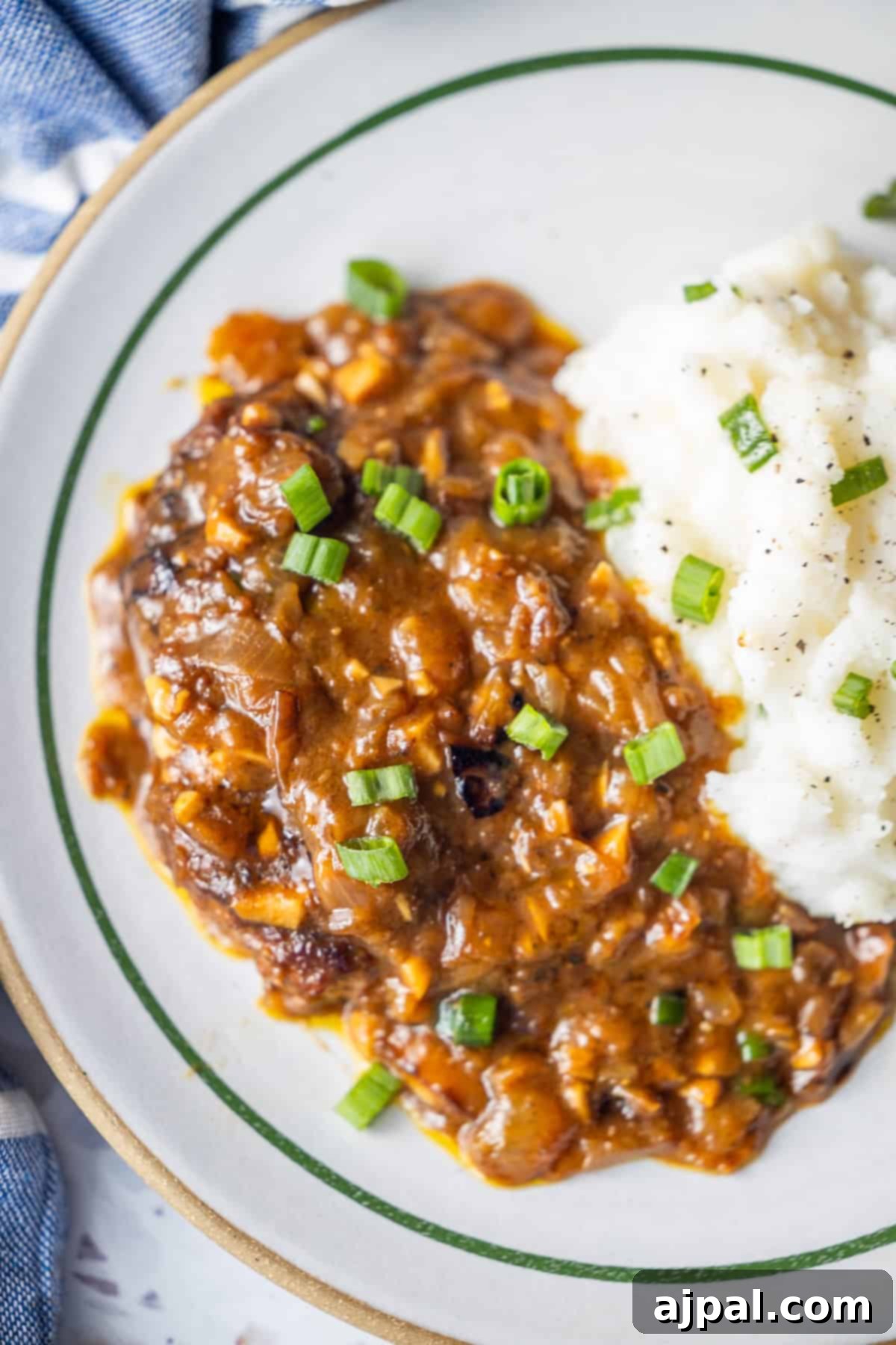 Country Steak in Gravy: A Hearty Homestyle Classic 5 Country steak with brown gravy, green onions, and mashed potatoes.