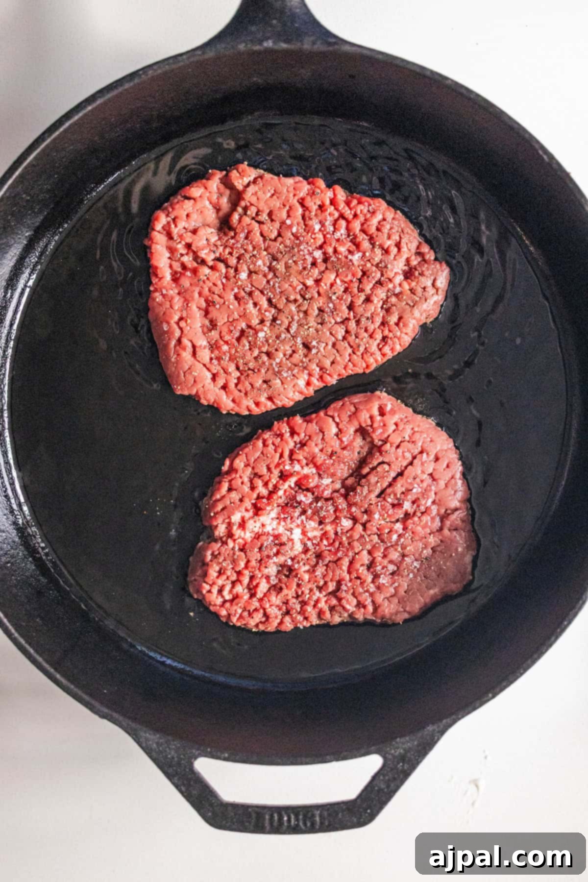 Country Steak in Gravy: A Hearty Homestyle Classic 7 Browning cube steak in a cast iron skillet.