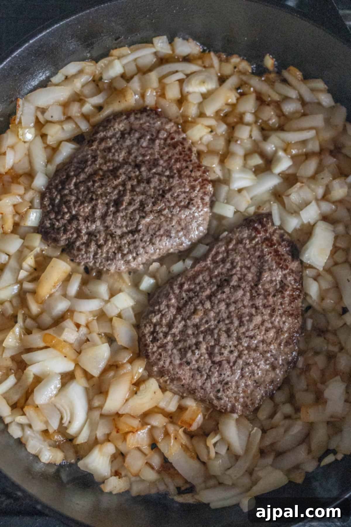 Country Steak in Gravy: A Hearty Homestyle Classic 8 Sautéing onions in the skillet.