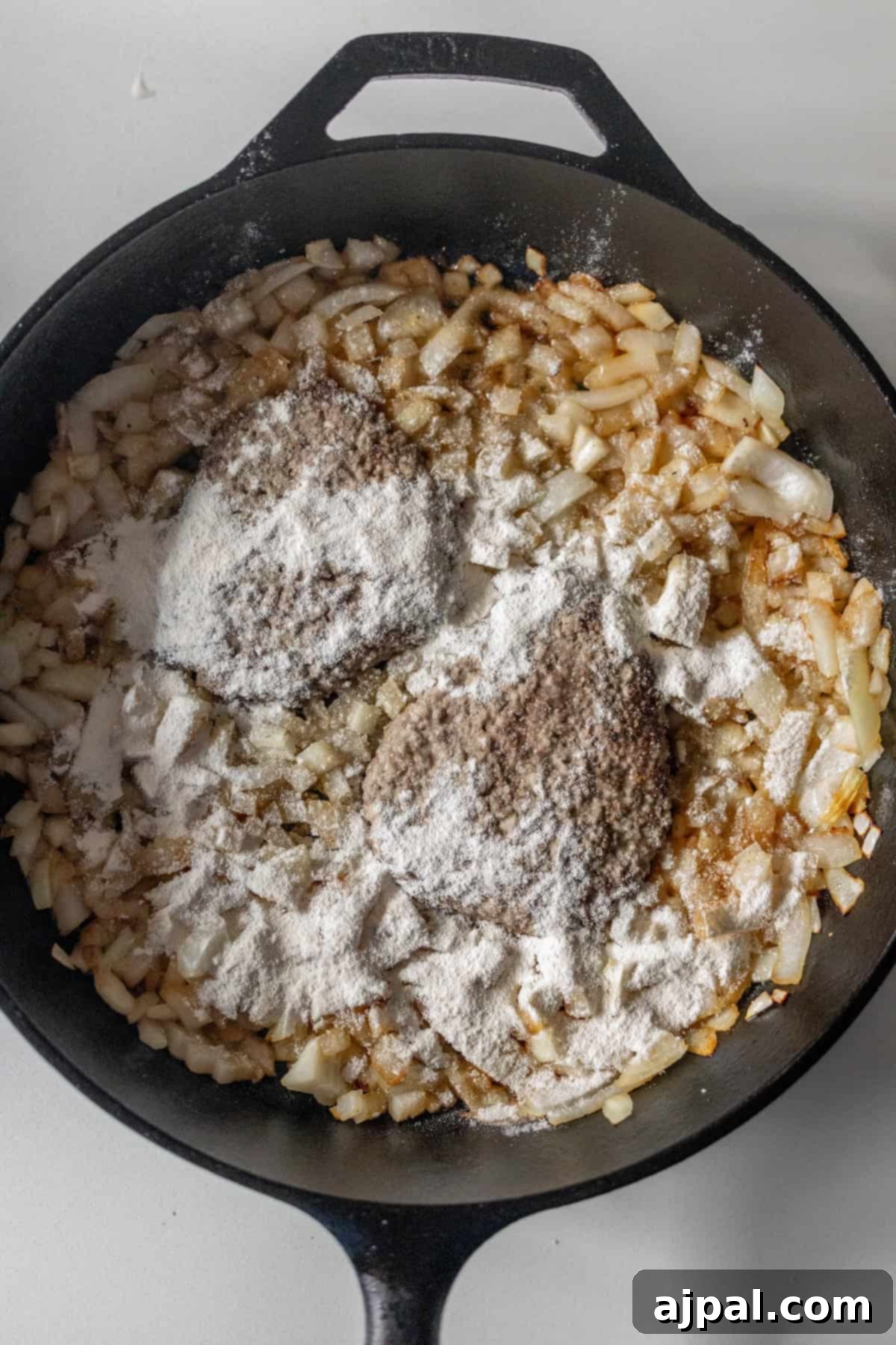 Country Steak in Gravy: A Hearty Homestyle Classic 9 Adding flour to the sautéed onions.