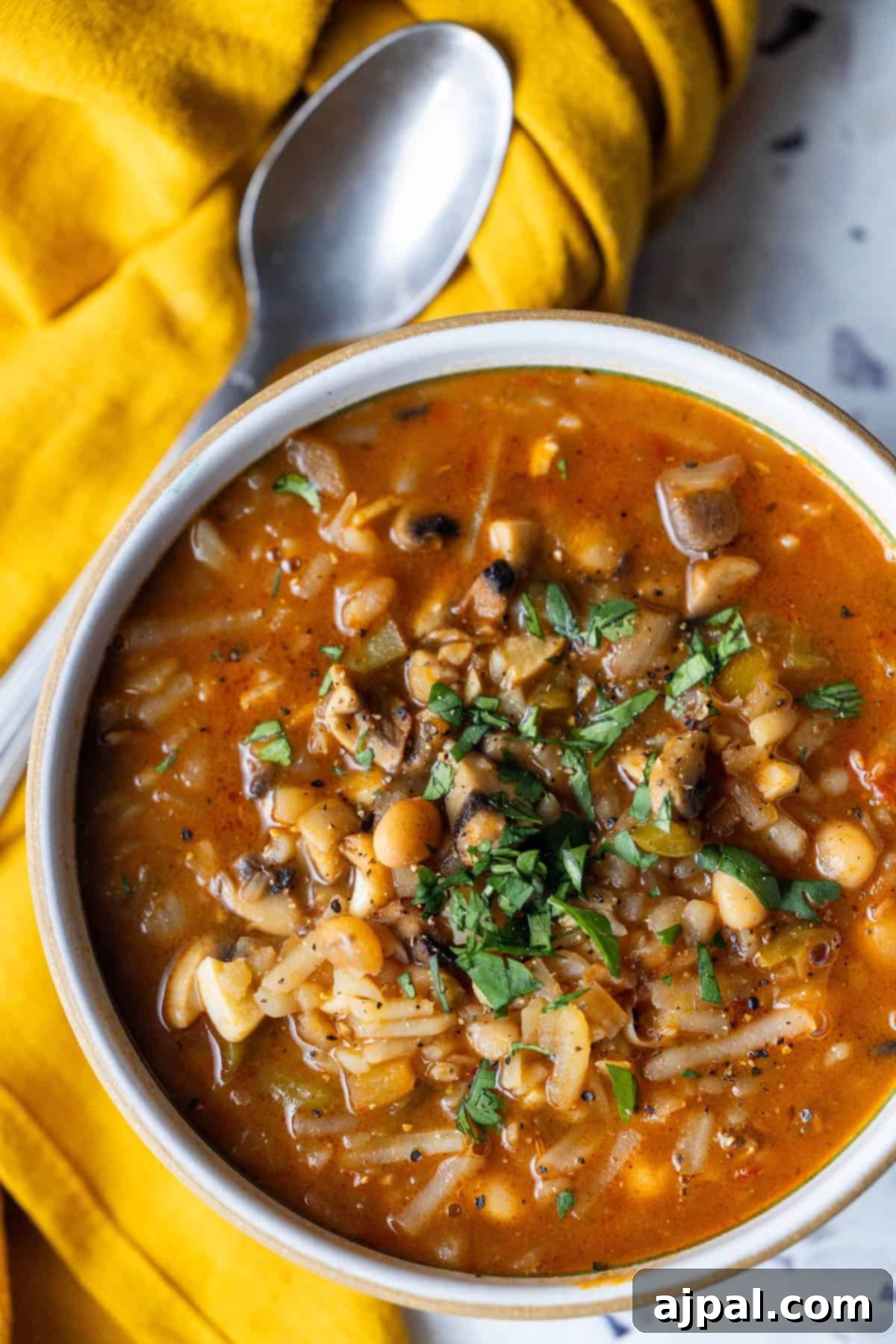 Vegan Crispy Potato Soup 4 A bowl of Vegan Hashbrown Soup with a spoon, ready to be enjoyed.