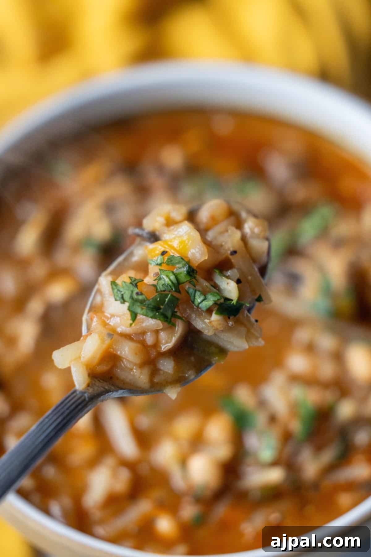 Vegan Crispy Potato Soup 5 A spoonful of Vegan Hashbrown Soup, highlighting the texture and ingredients.