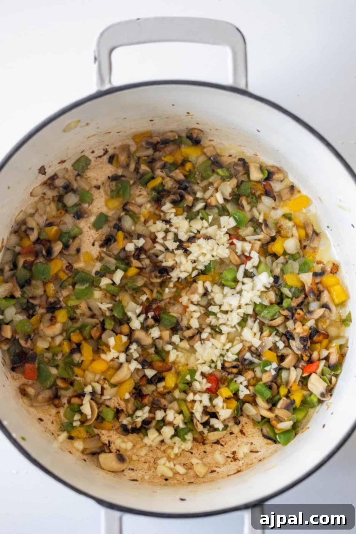 Vegan Crispy Potato Soup 7 Chopped vegetables sautéing in a pot.