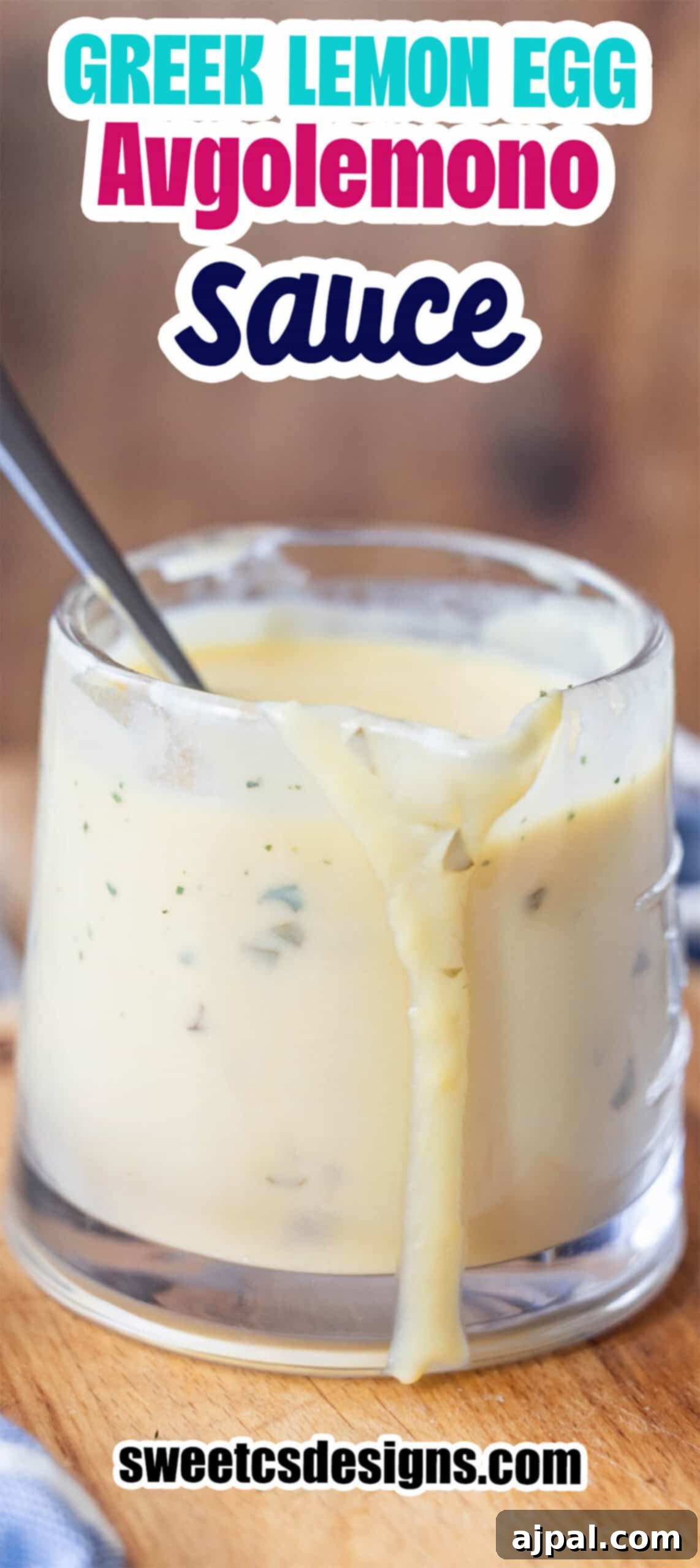 Greek Lemon-Egg Sauce 11 A glass cup filled with Greek avgolemono sauce, some of the silky avgolemono sauce dripping down the side, and a spoon nestled inside.