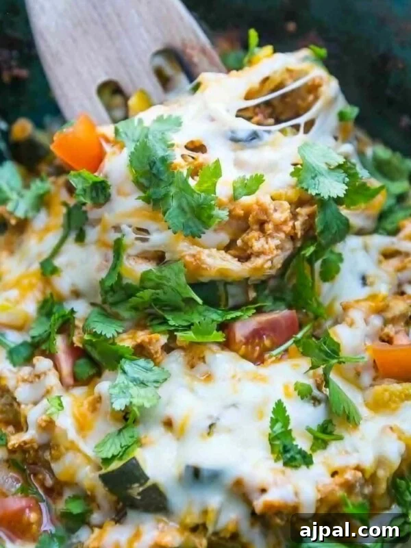 A bowl of Mexican veggie enchiladas with a wooden spoon, inspired by slow cooker chicken tacos.
