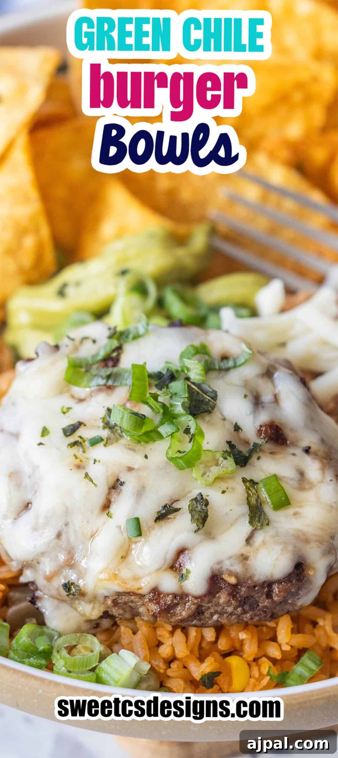 A cheeseburger patty topped with melted cheese and green onions sits on a bed of rice, creating a delicious Burger Bowl with hints of green chile, served alongside chips and guacamole in the background.
