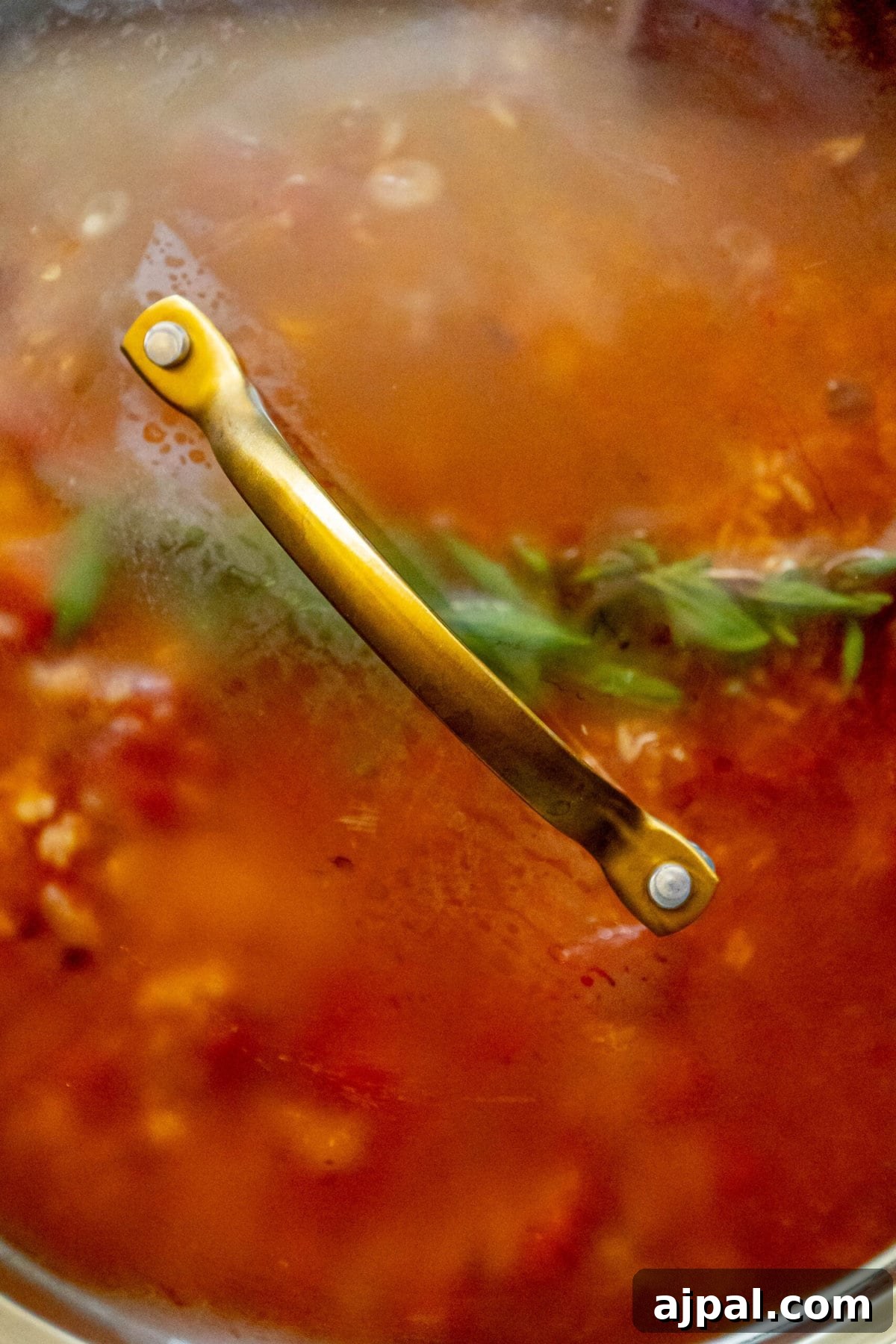 mexican rice cooking in a pan with the lid on