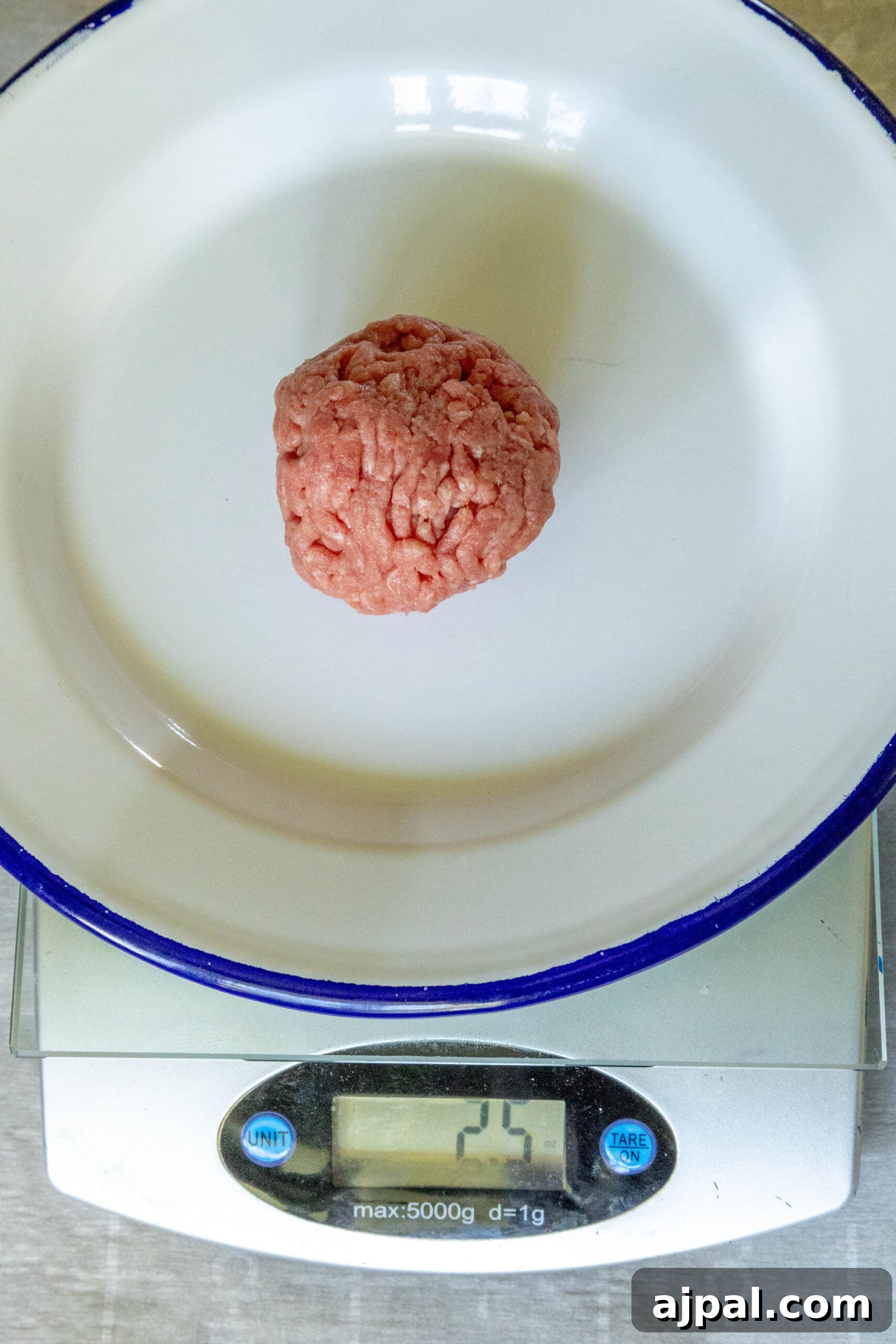 picture of ground beef in a ball on a scale