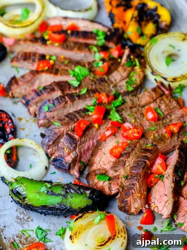 Authentic Mexican Charro Beans Recipe with Bacon and Chiles 11 Grilled steak with peppers and onions on a baking sheet prepared using a carne asada recipe.