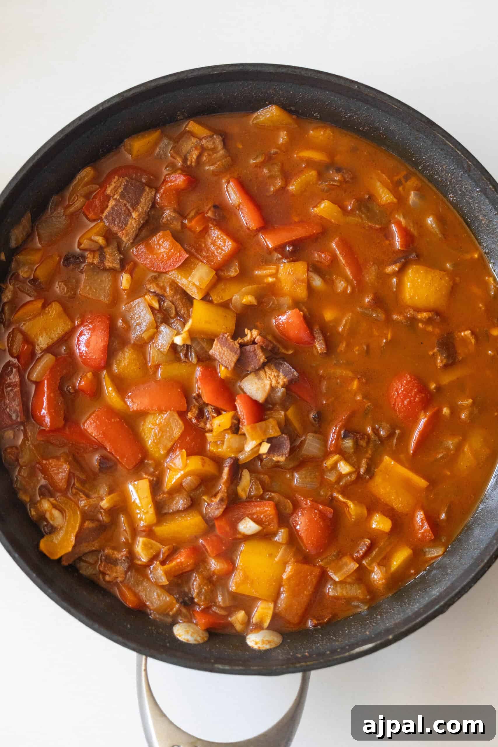 Authentic Mexican Charro Beans Recipe with Bacon and Chiles 7 Tomato-based stew with peppers, bacon, onions, and beans.